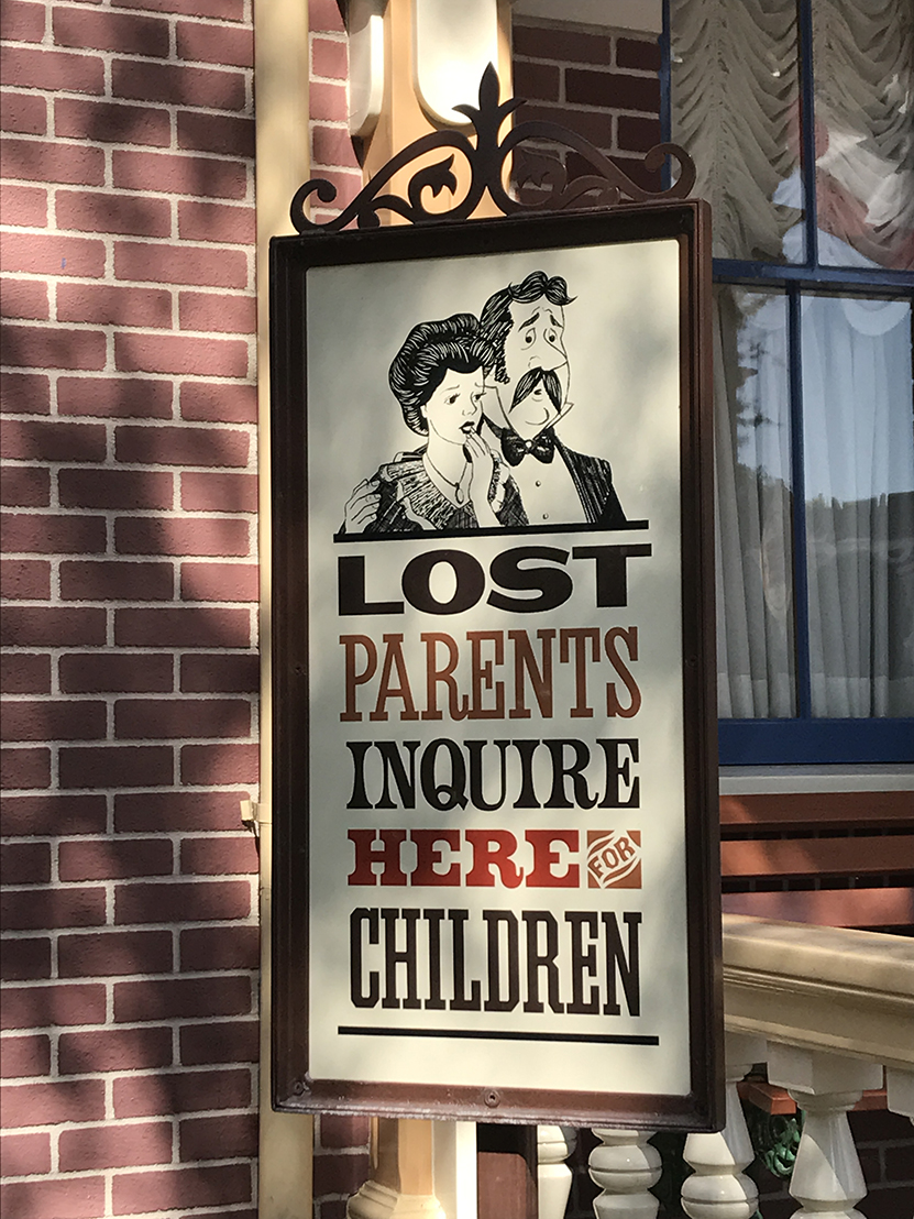 Funny sign in Main Street USA Lost parents Inquire Here for Children featuring Mr and Mrs Darling from Peter Pan