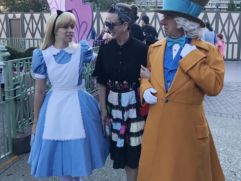 Alice, Shannon Laskey and the Mad Hatter stroll through Fantasyland in Disneyland