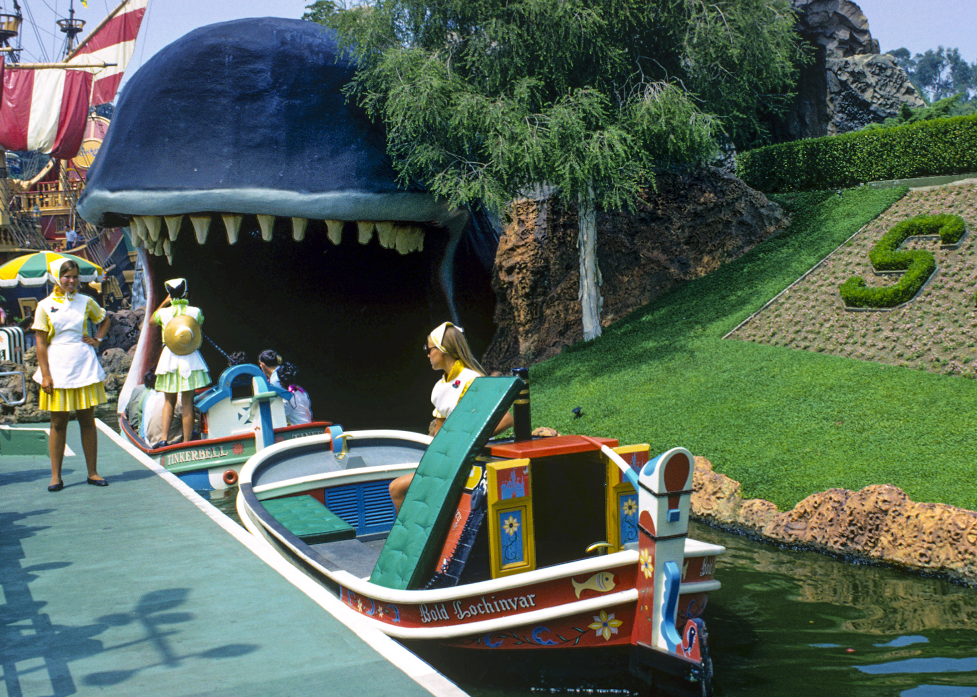 Cast Members work loading area near Monstro the Whale on Storybook Land Canal Boats